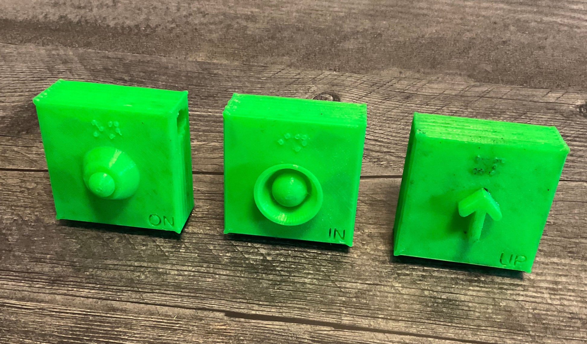 3 green square beads with a different symbol on each On In Up