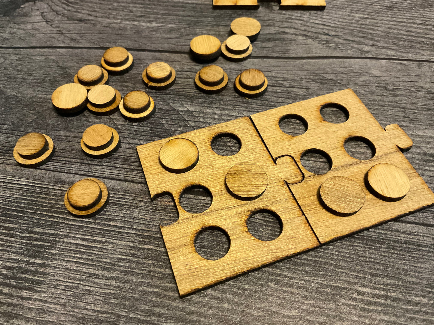 Another picture of the puzzle pieces and a pile of pegs.