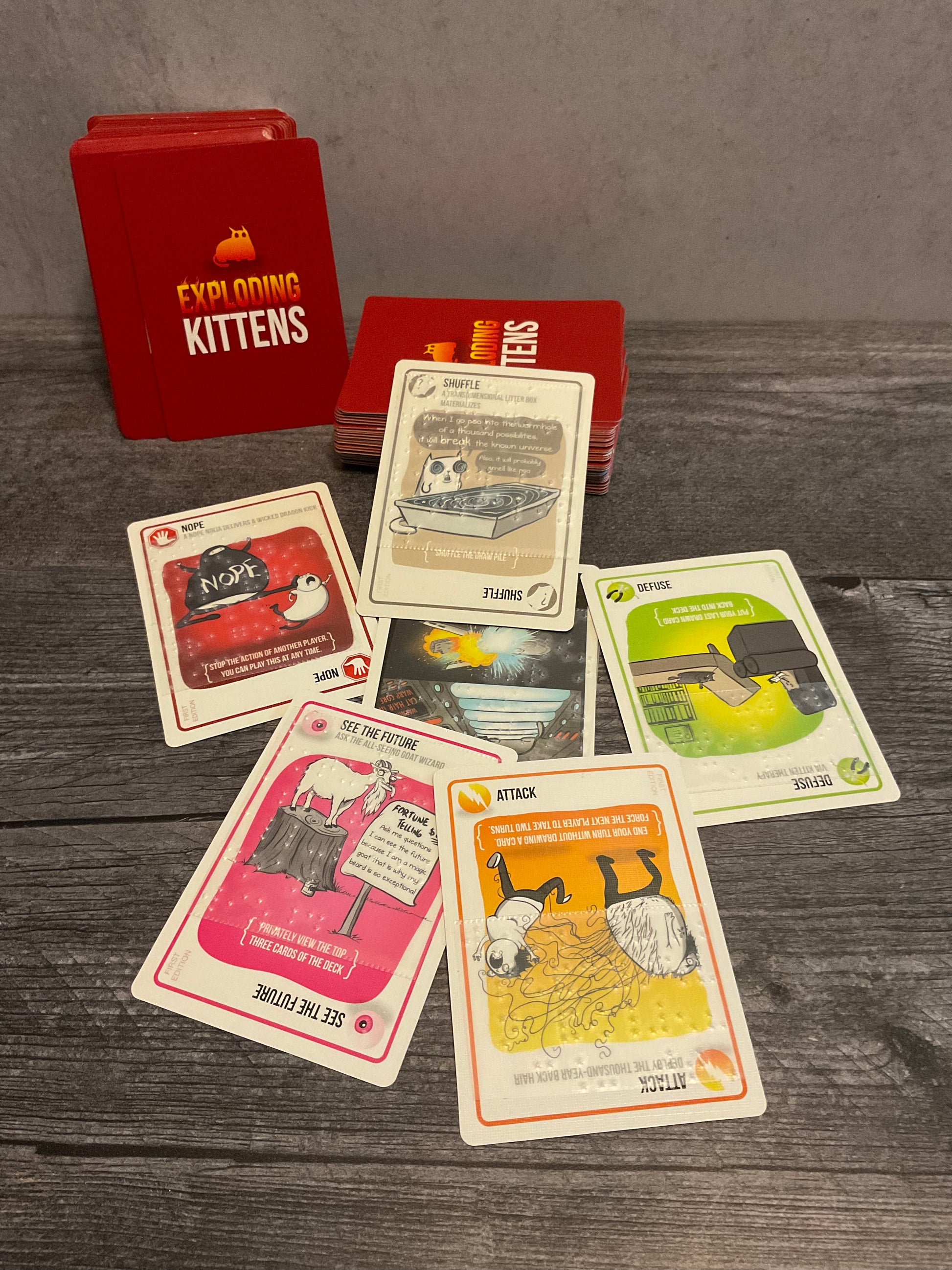 The cards are shown here. The cards have the flavor text in braille for the game instead of the full text of the card function. The card function is embossed on reference sheets since there are very few of them and you learn them very quickly.