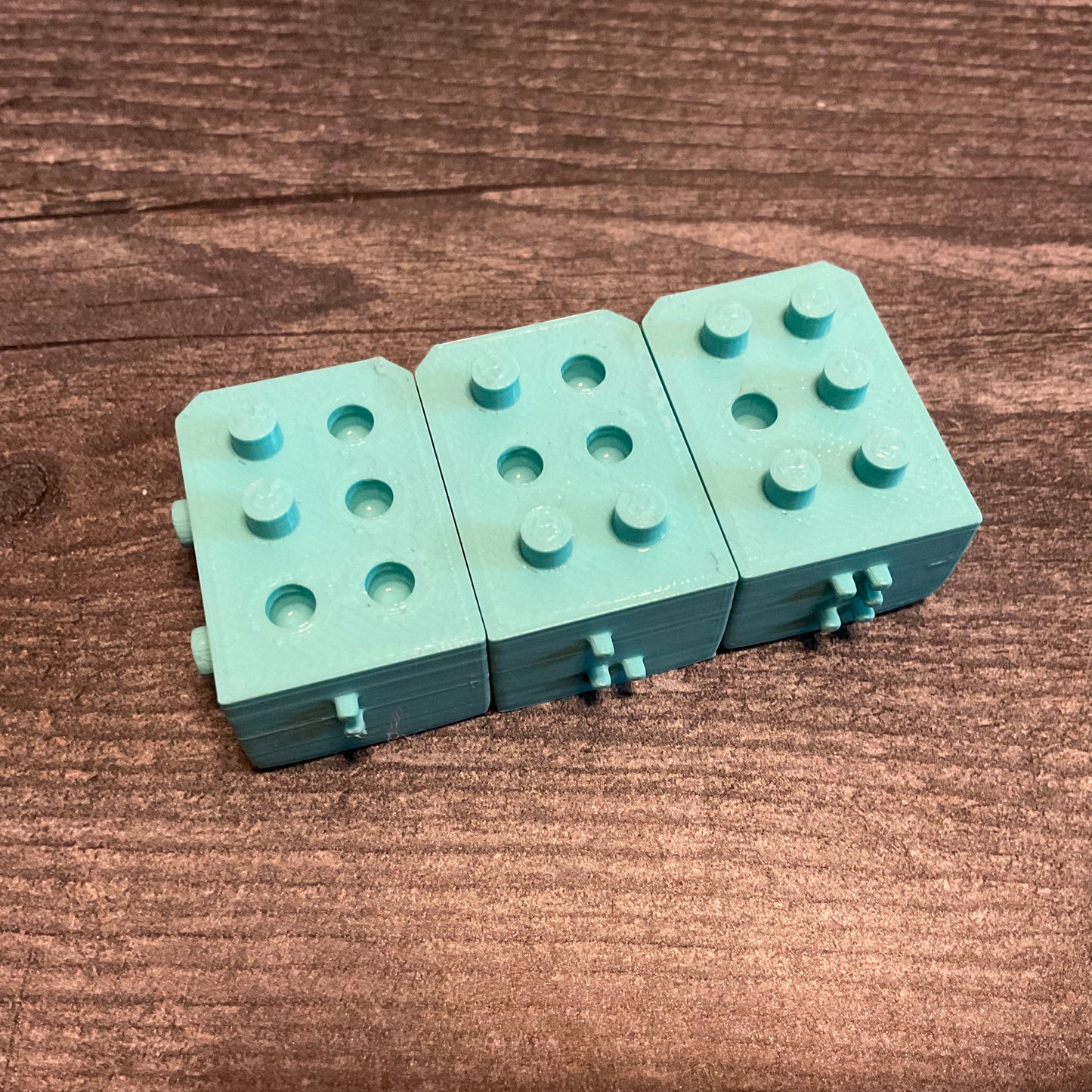 3 blocks placed together with the not so subtle subliminal message of BUY spelled out.