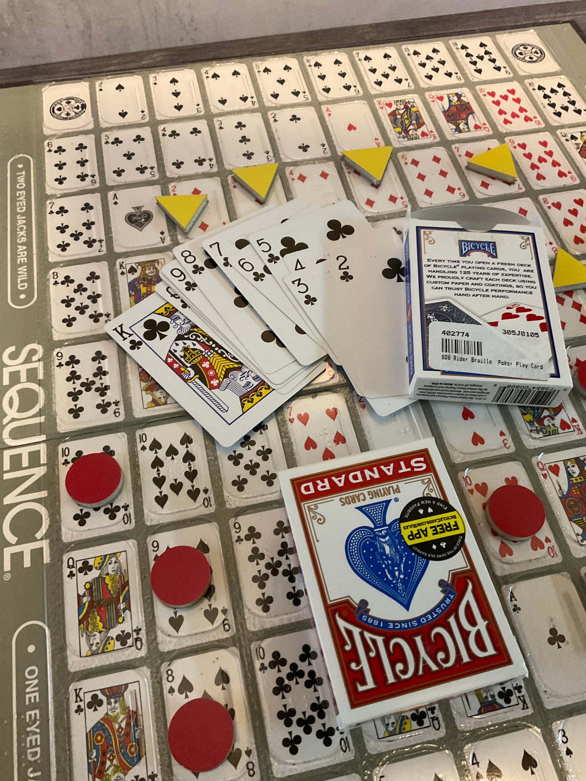 Closer shot of the board with the thermoformed overlay. Yellow triangle tokens and red circles can be seen on the board