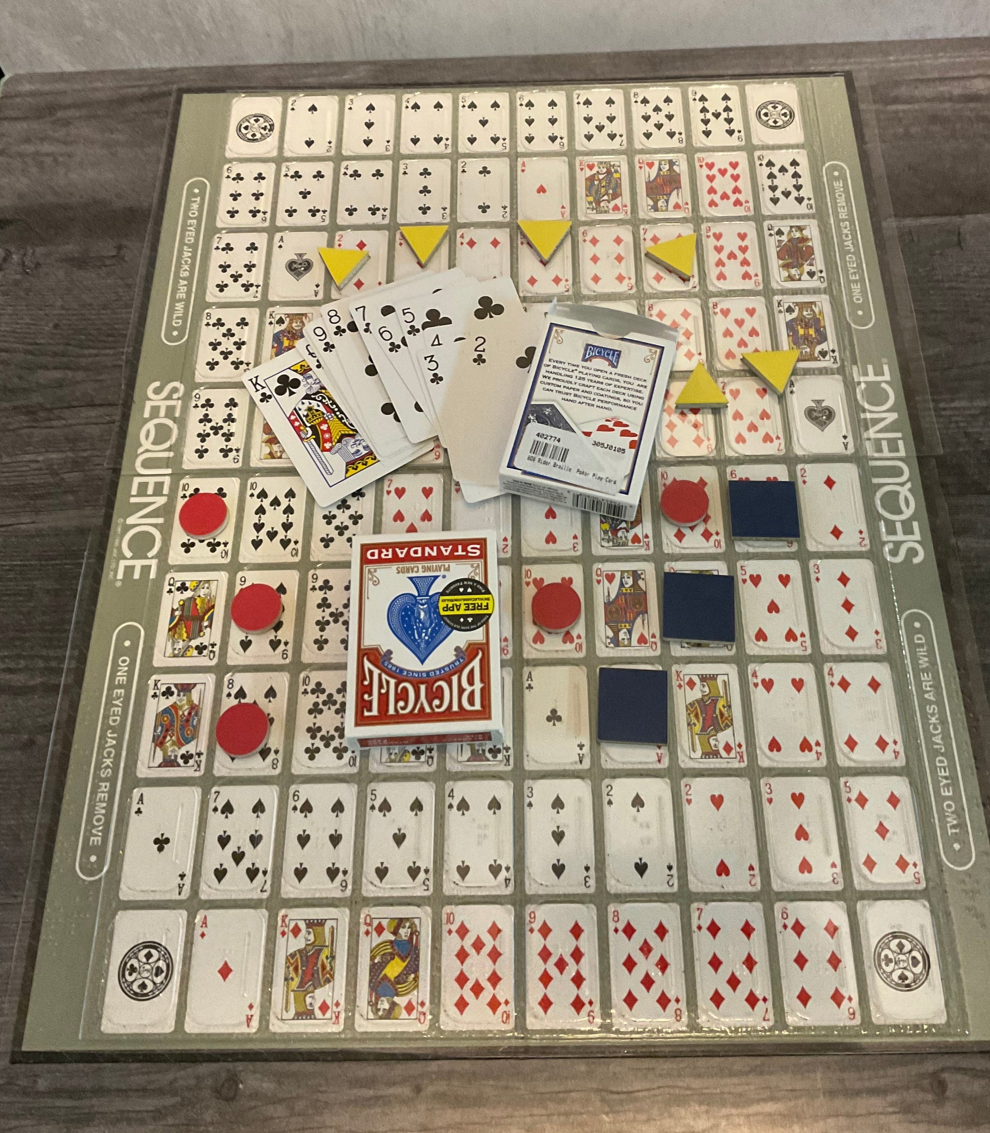 shot of the sequence board with the replacement braille cards. Shaped foam tokens replace the poker chips.