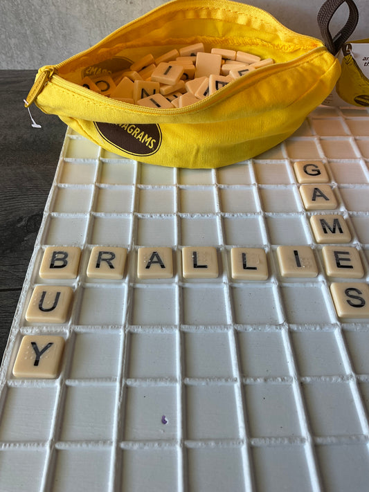 A picture of the tiles in the tray with the words "buy braille games" spelled out.