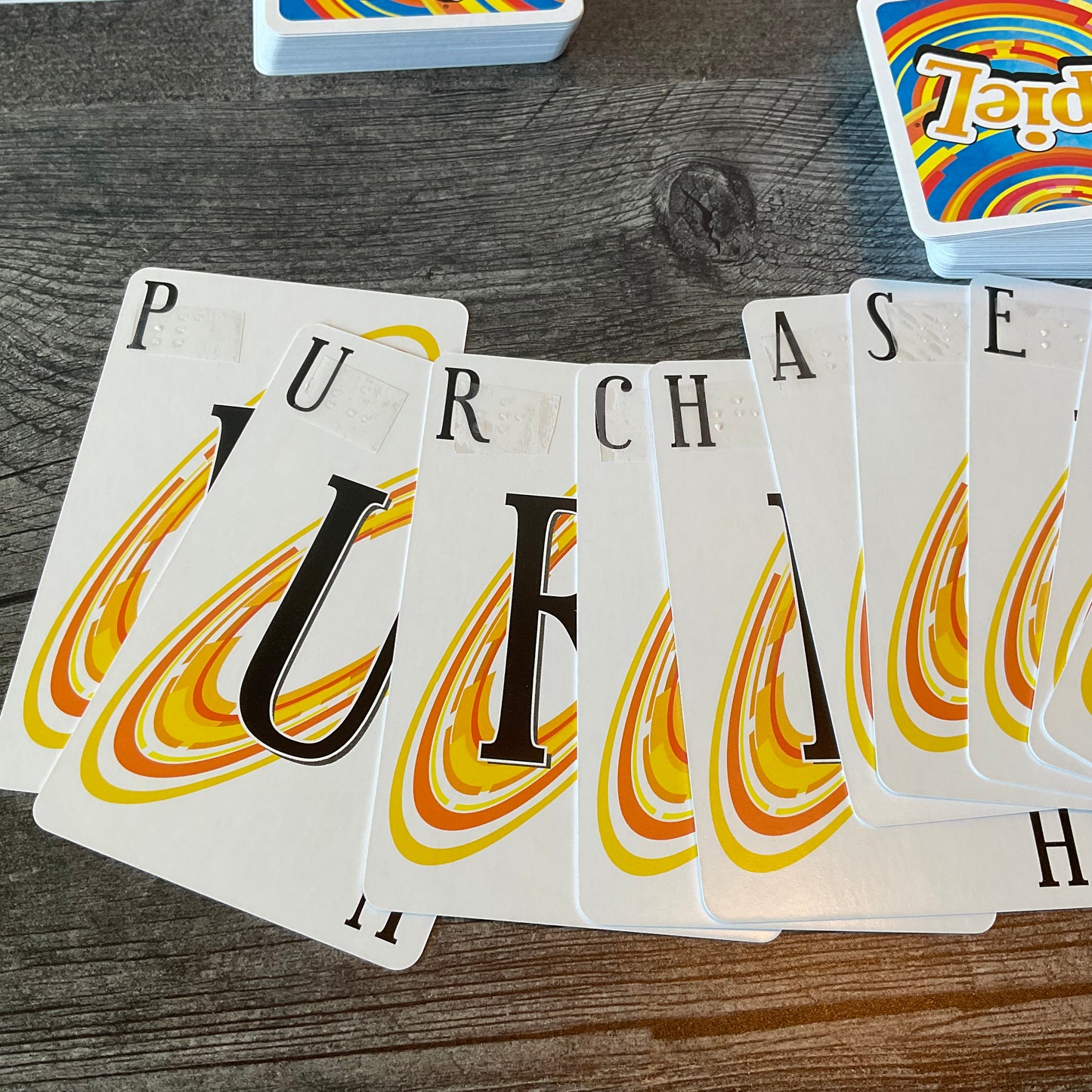 A close up of the cards with the braille on them. The word purchase is spelled out.