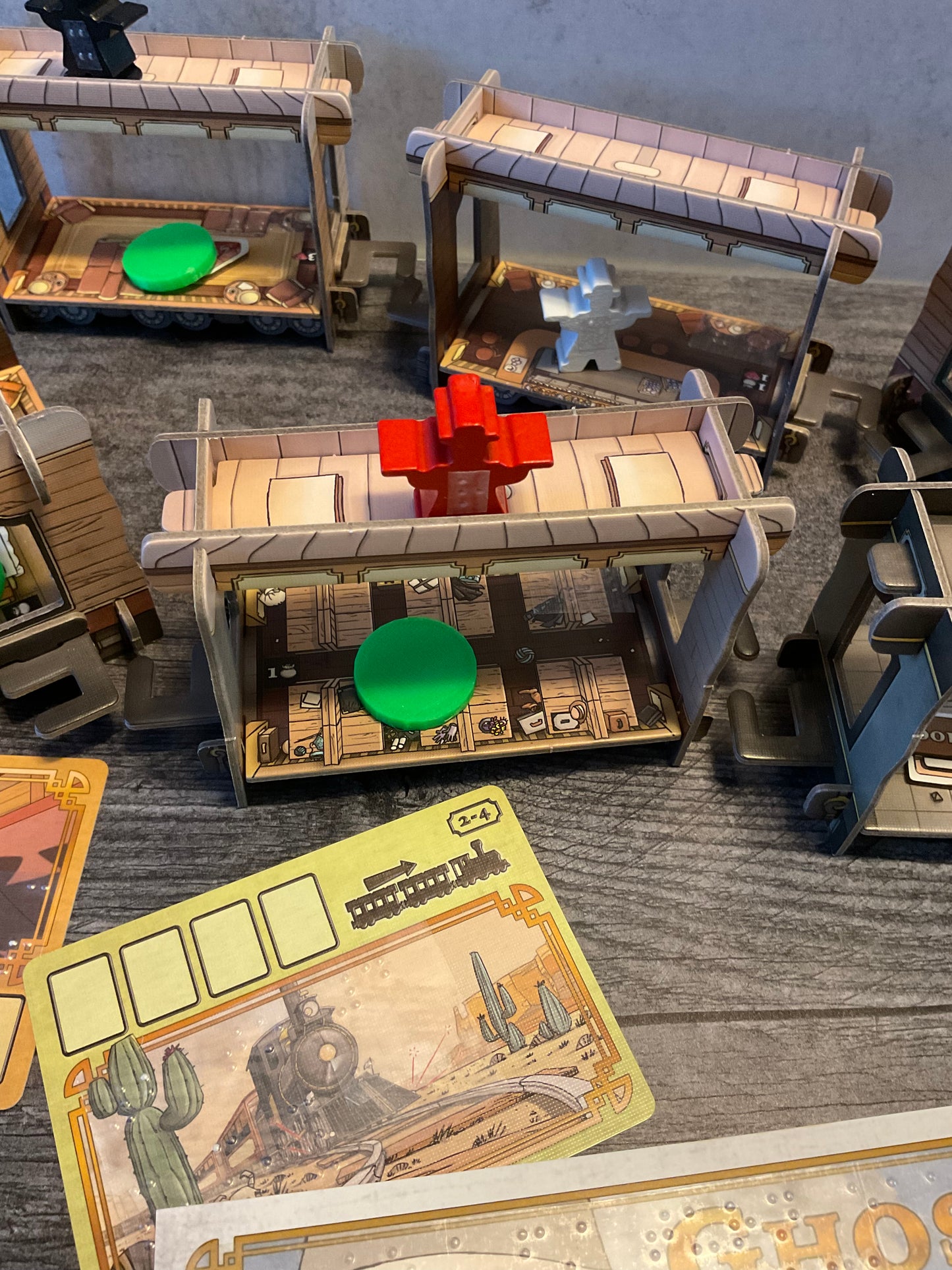 An action shot of a red meeple on top of the train. The red meeple has an R on it to distinguish it from the other colors.