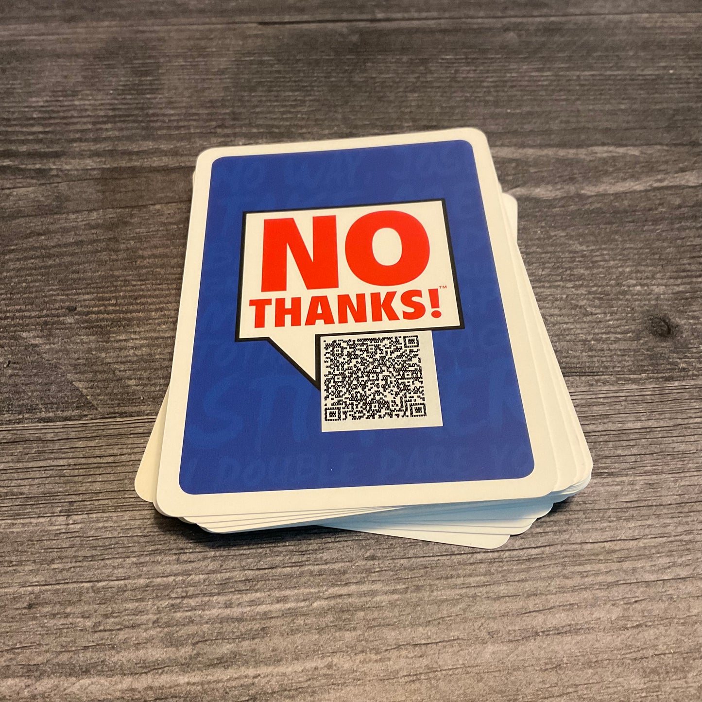Shot of the back of the cards with the QR code that has the flavor text on it.