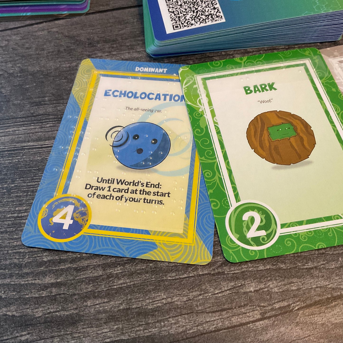 A close up shot of 2 of the traits showing the transparent braille stickers