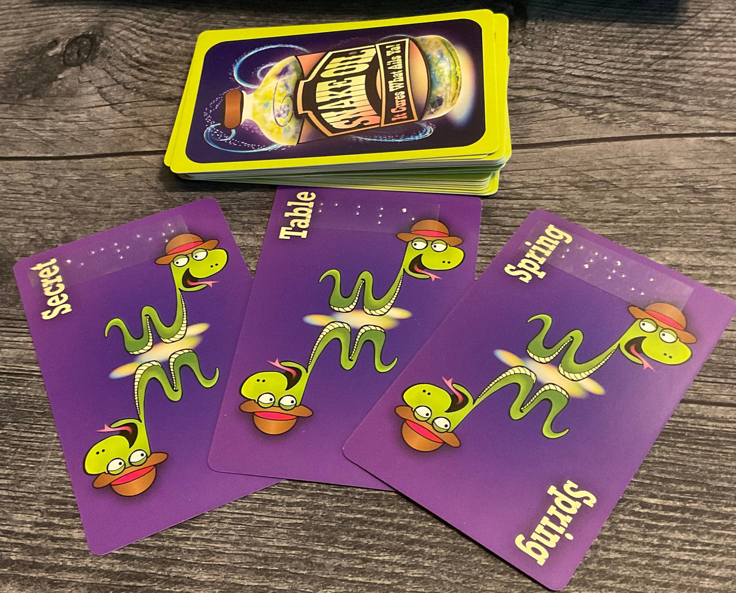 Product cards for secret, table and spring. All have transparent braille on them