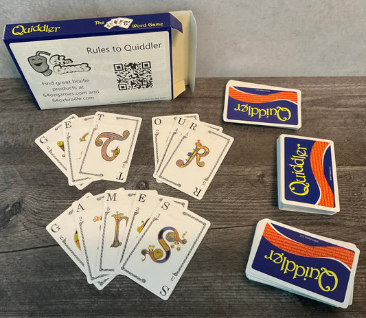 Cards laid out with transparent braille on them. The words "Get" "our" "games" are spelled out with the cards.