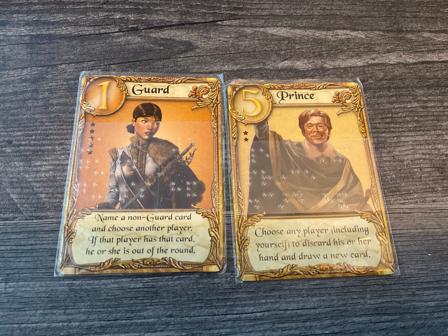 The guard and prince cards close up. Both have braille on them