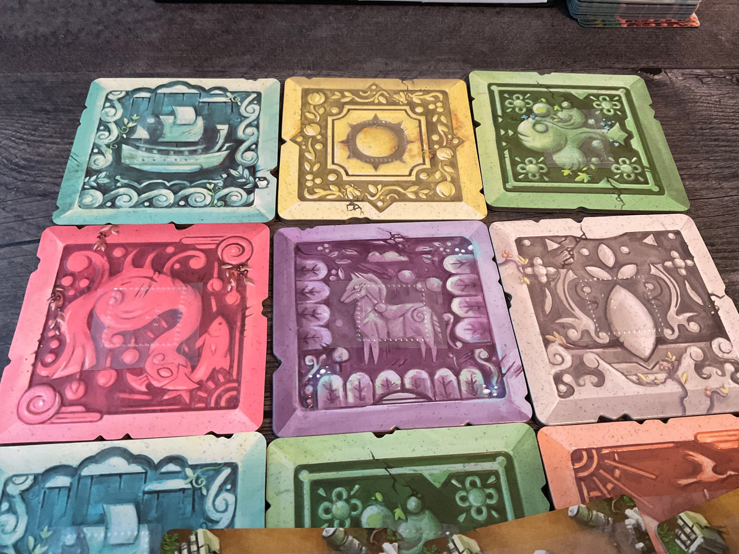 A close up of the 3x3 grid of tiles that makes up the 'board'. Each tile has a letter on it to designate it's color