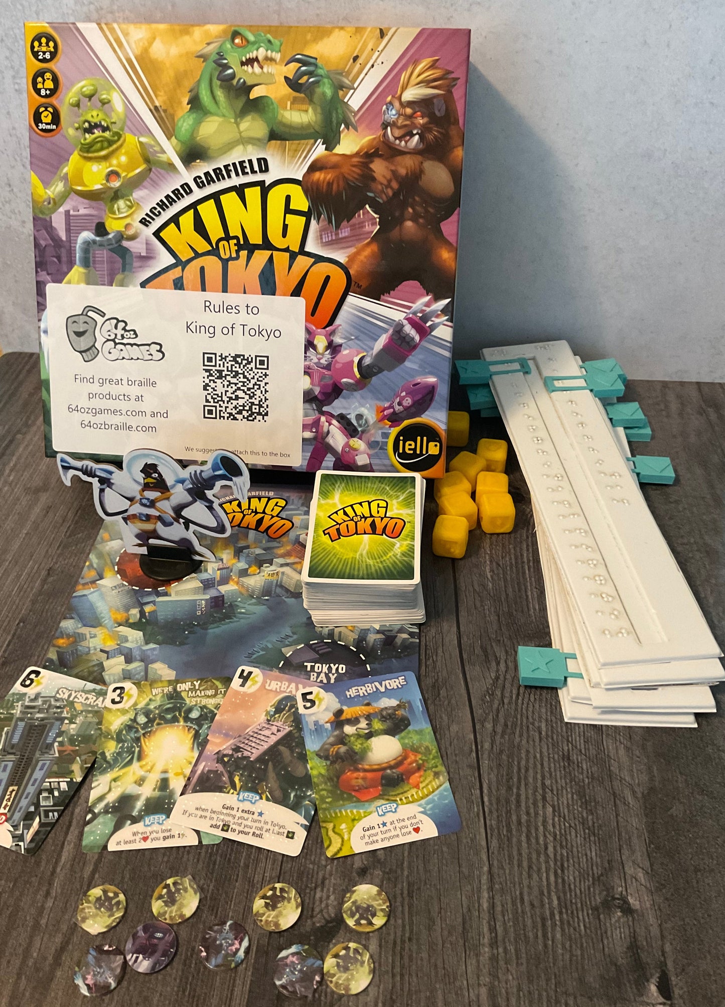 The game with the accessibility kit. Tokens with braille, plastic replacement sliders for tracking stars and hp, replacement 3d dice and cards with braille on them.