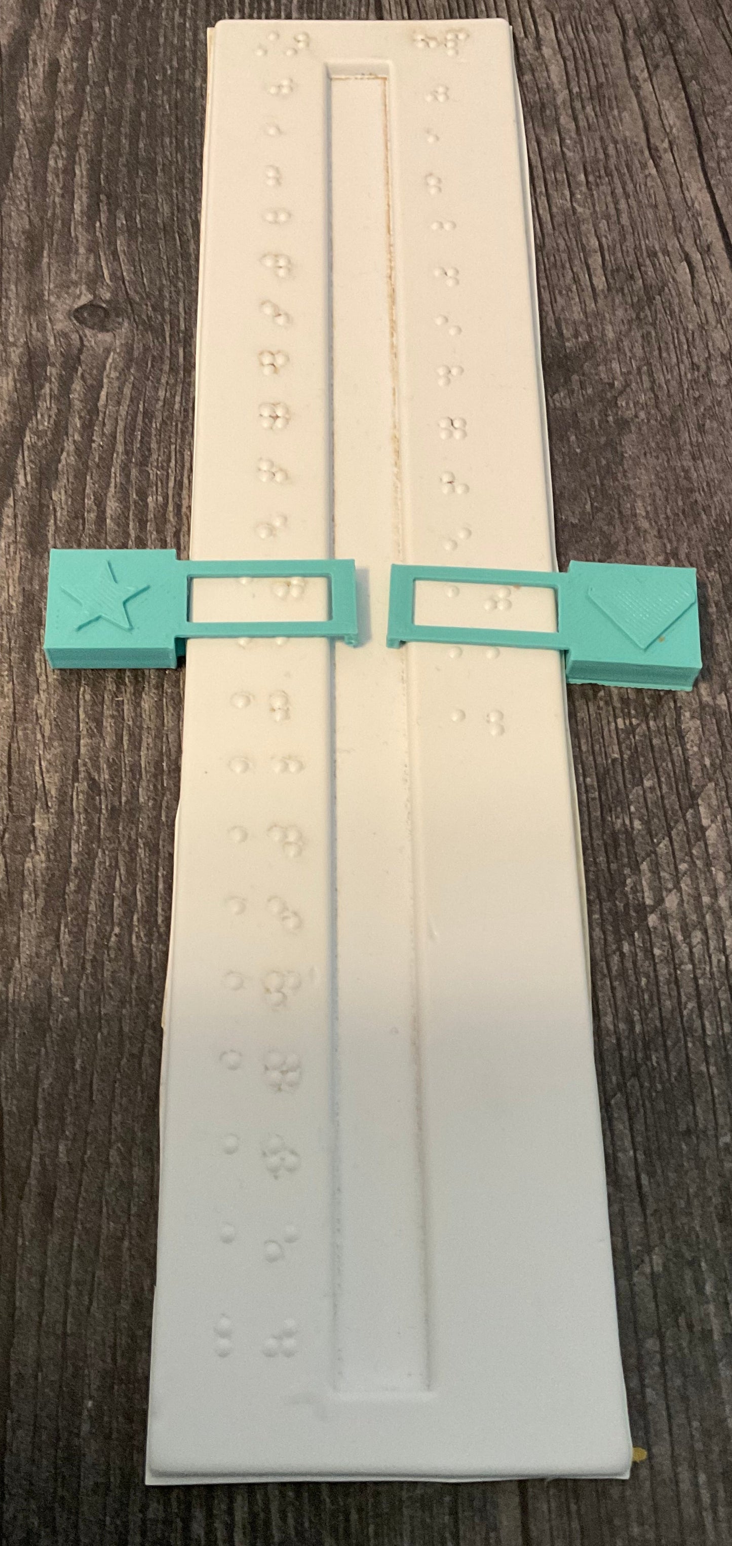 Plastic sliders with braille on them to track stars and hp