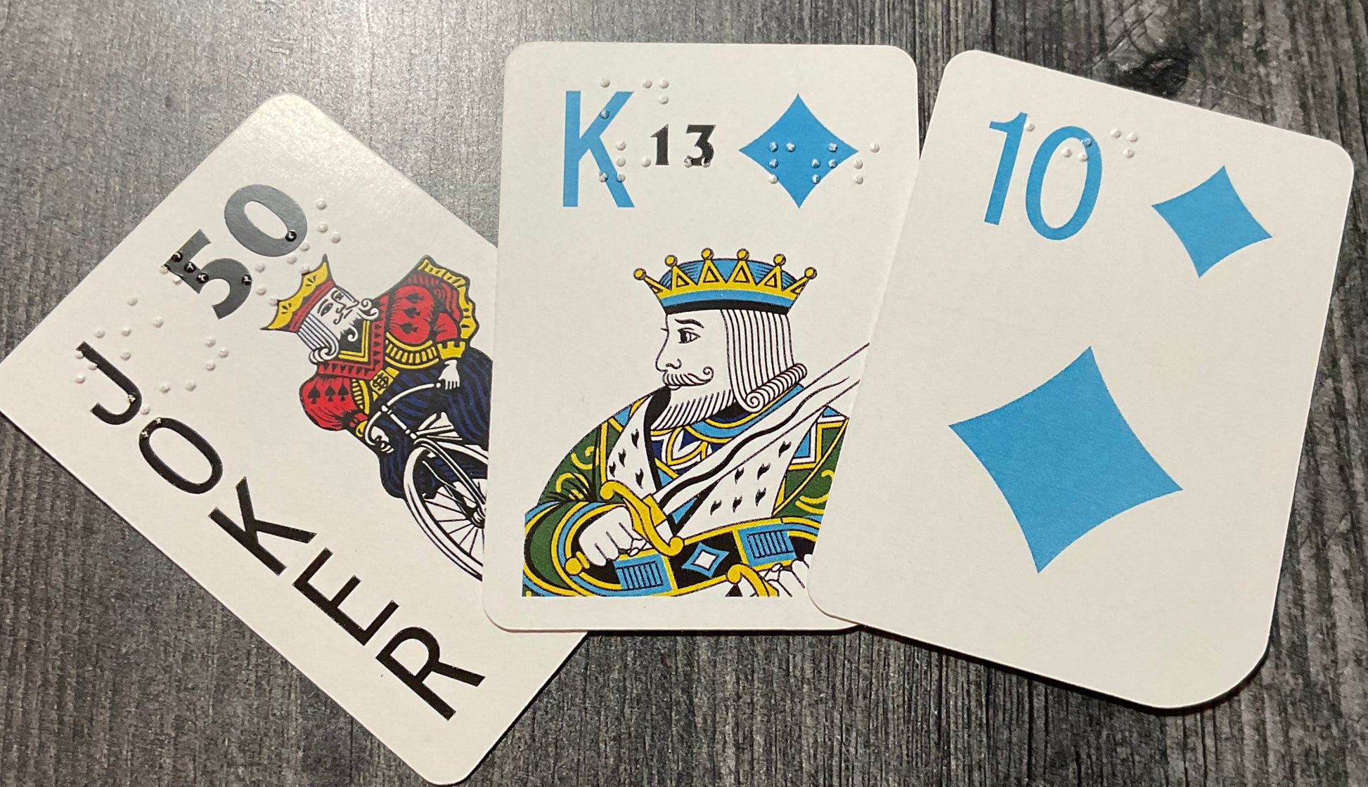 A Joker card, a King of diamonds and a 10 of diamonds