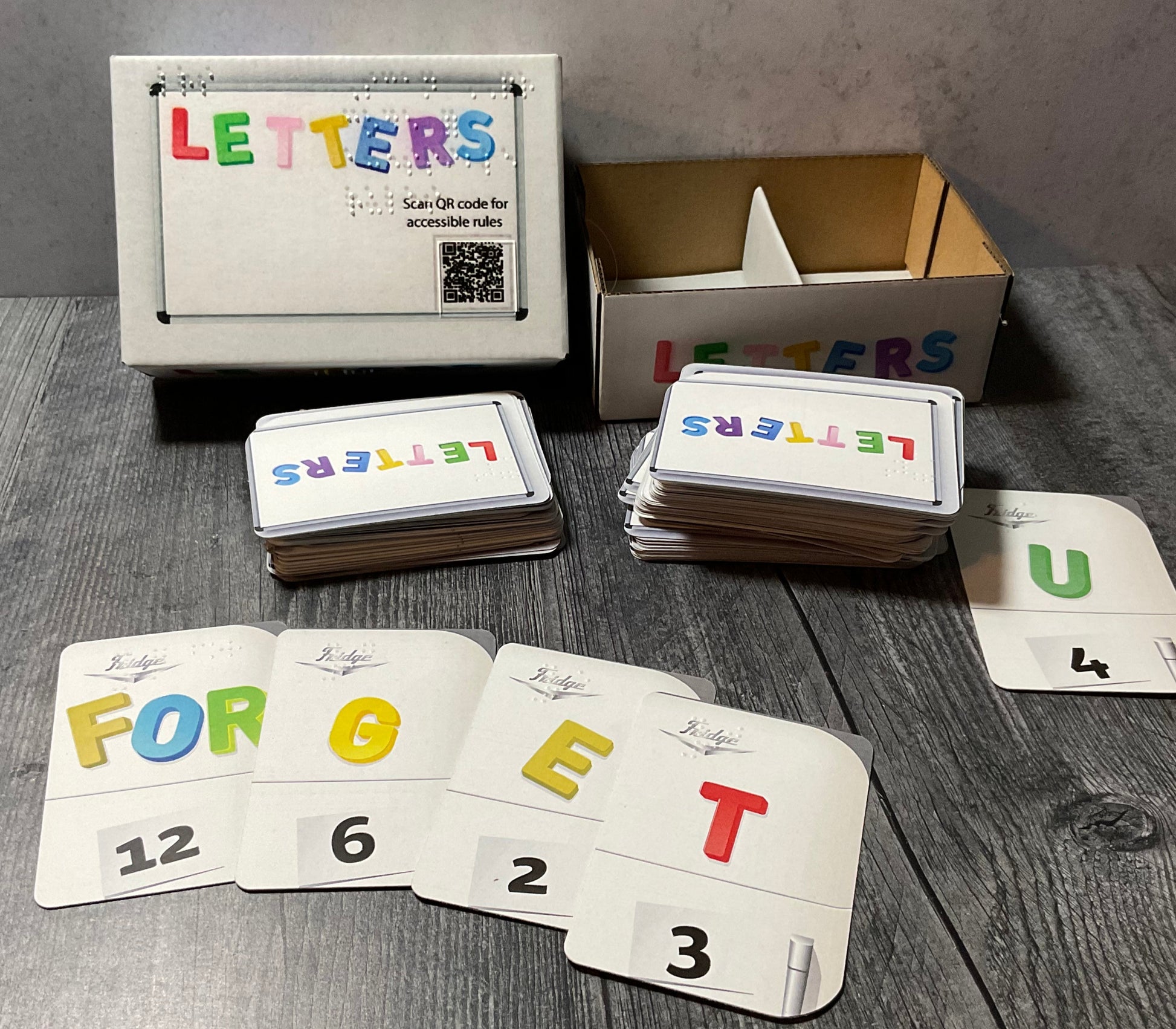 A picture of the Letters box with the letters laid out in front of it.