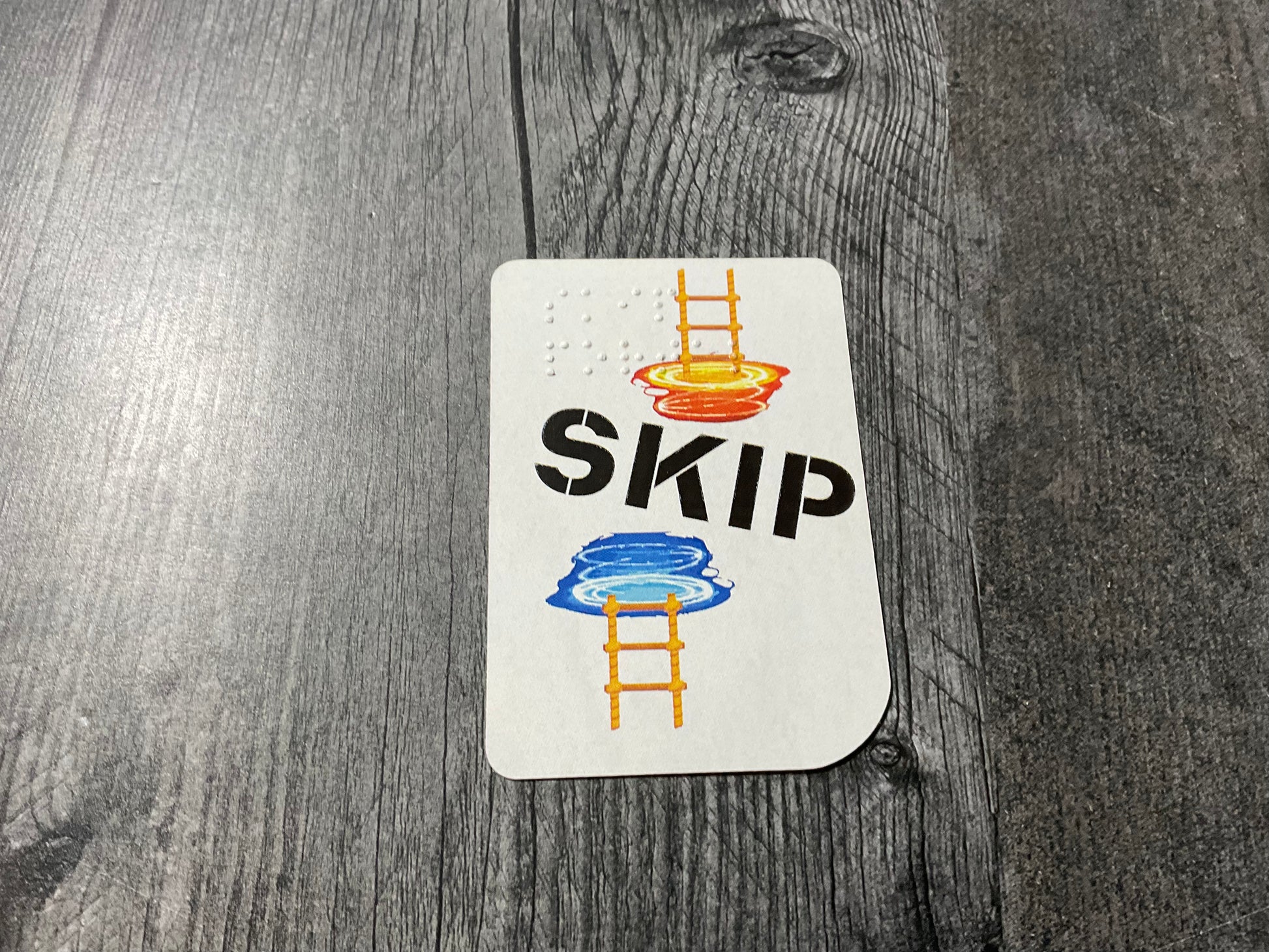 Close up on a skip portal card. It shows a later going into and coming out of a portal.
