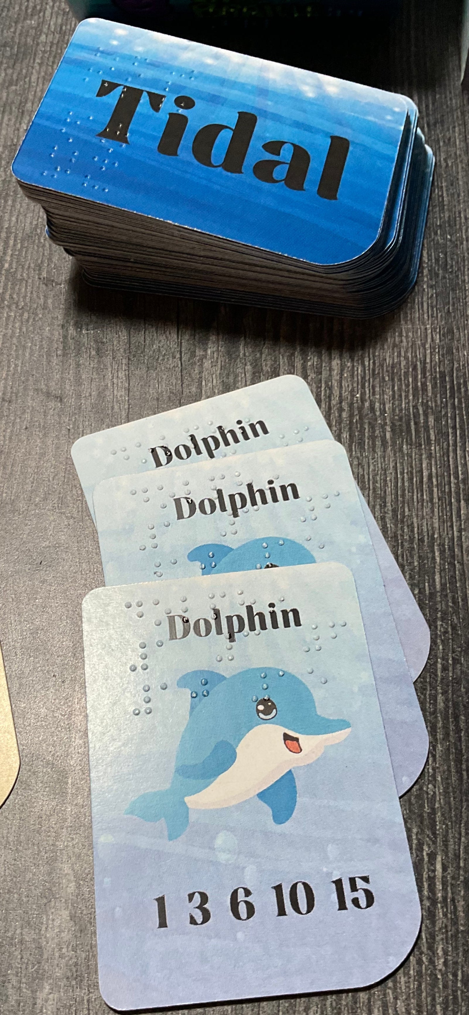 The draw deck with a stack of dolphin cards in front of it.
