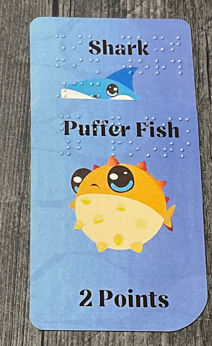 A close up of the shark and puffer fish cards