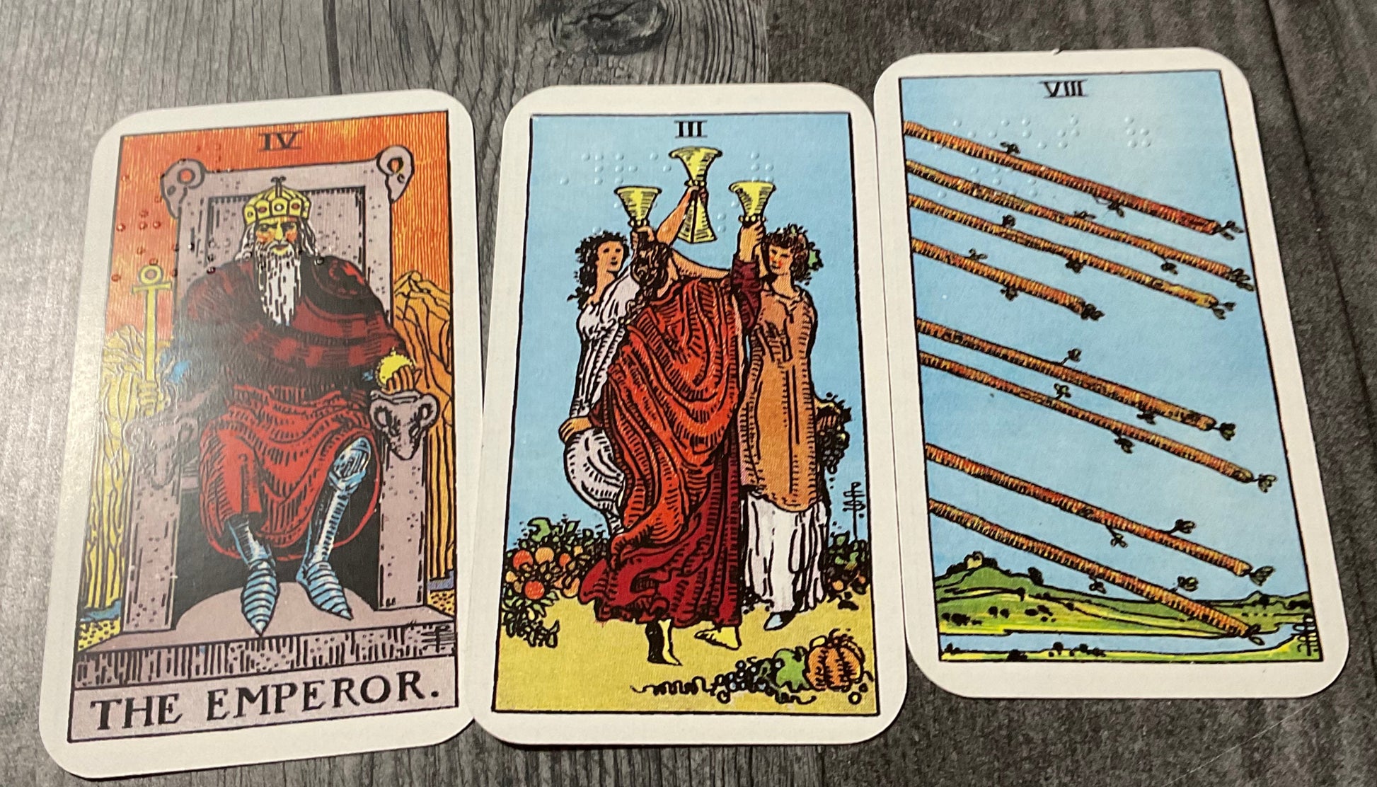 A picture of the emperor, the 3 of cups and the 8 of sticks