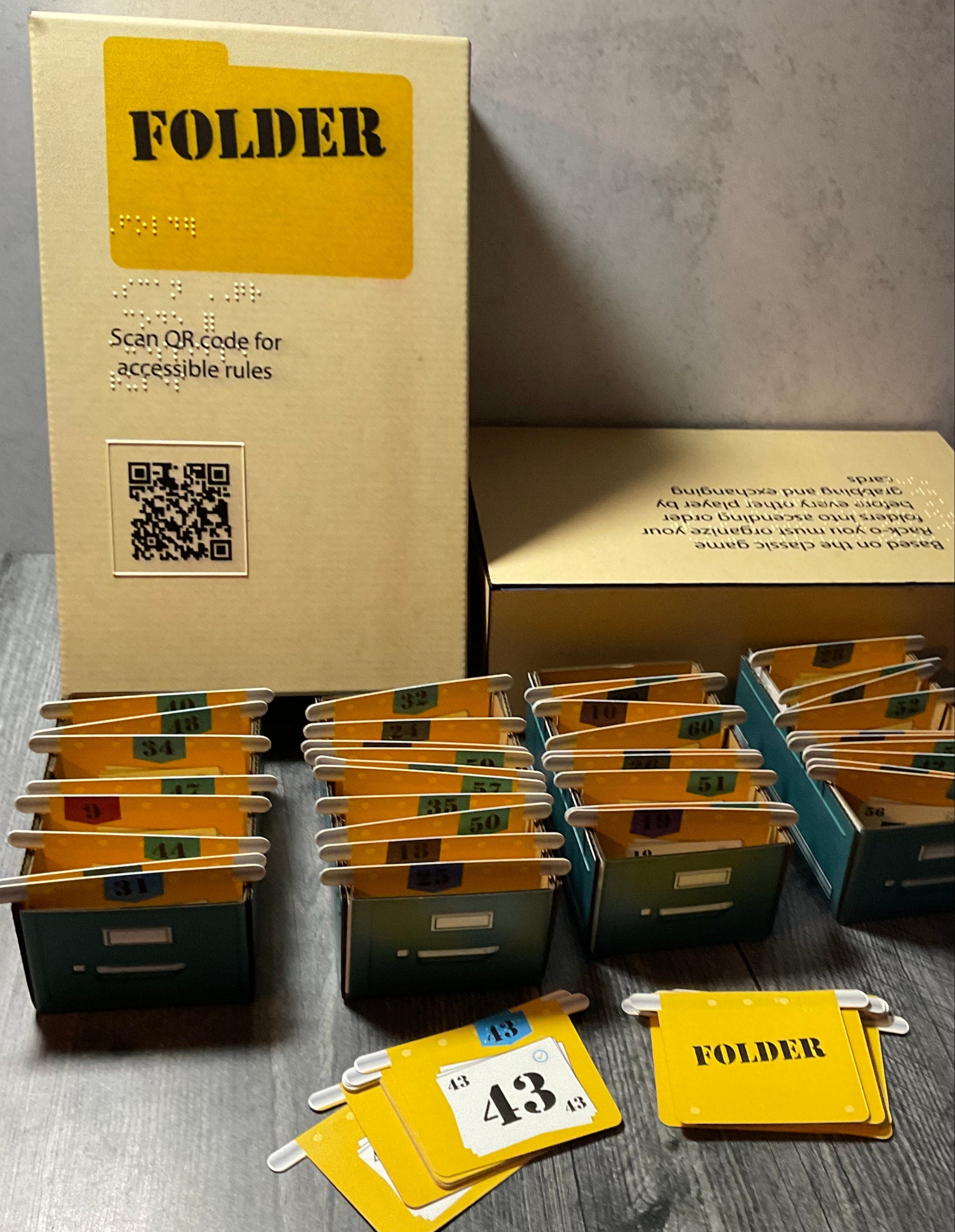 A picture of the Folder box with the different cardboard filing cabinets in front. Each one has a bunch of folder shaped cards in it.