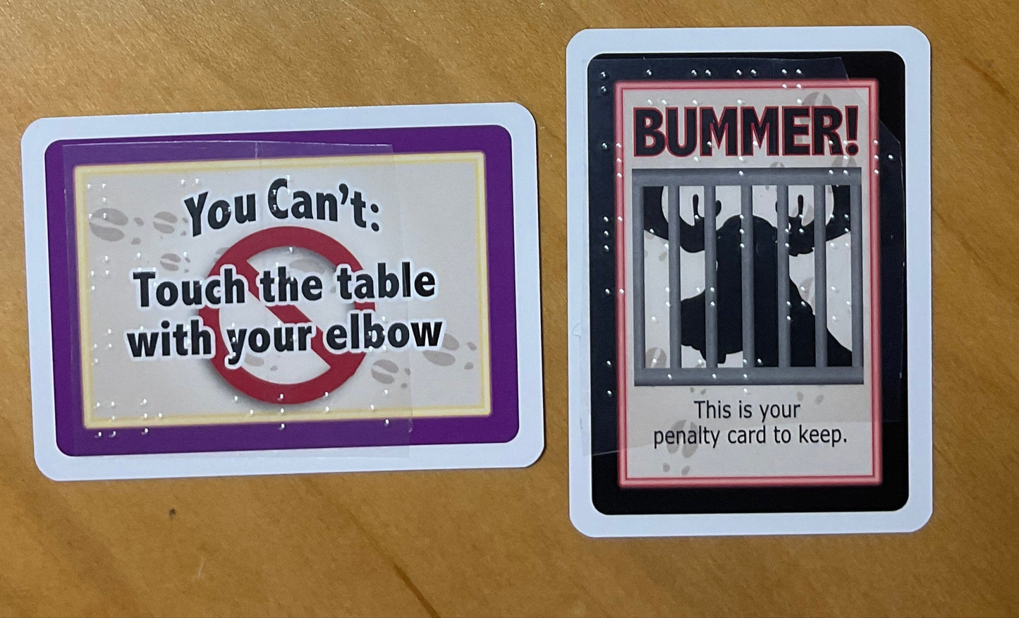 Close up on a Moose Rules card and a Penalty Card