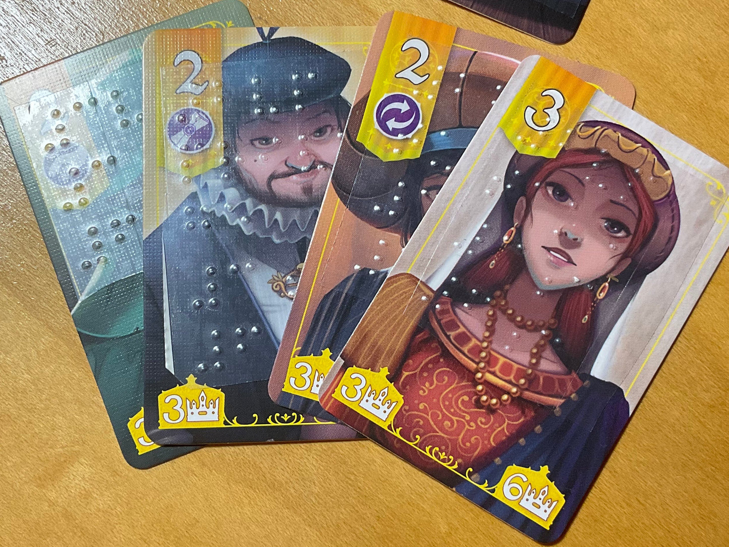 Close up on noble cards showing braille stickers on the cards.