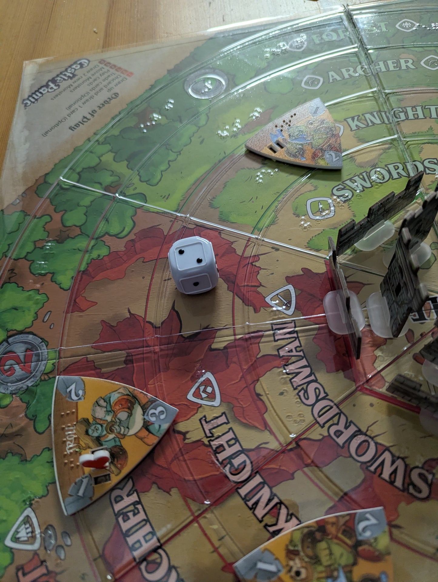 A picture of the board with tokens and the replacement tactile dice.