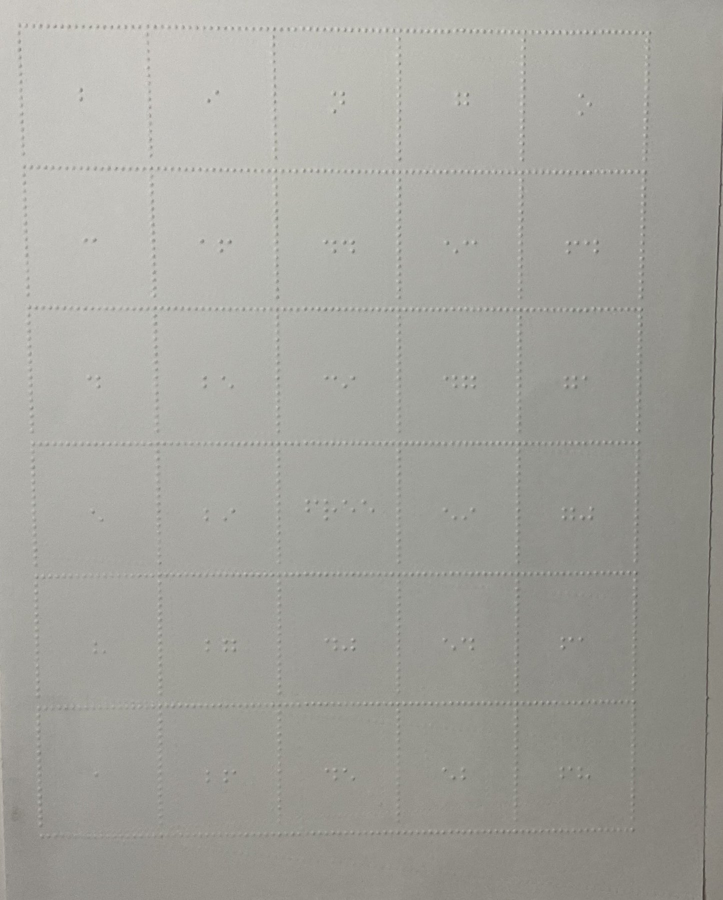 The braille bingo card shown. It is embossed on a piece of card stock paper with bingo in braille at the top. Random numbers are in each row allowing many people to play with no repeating cards
