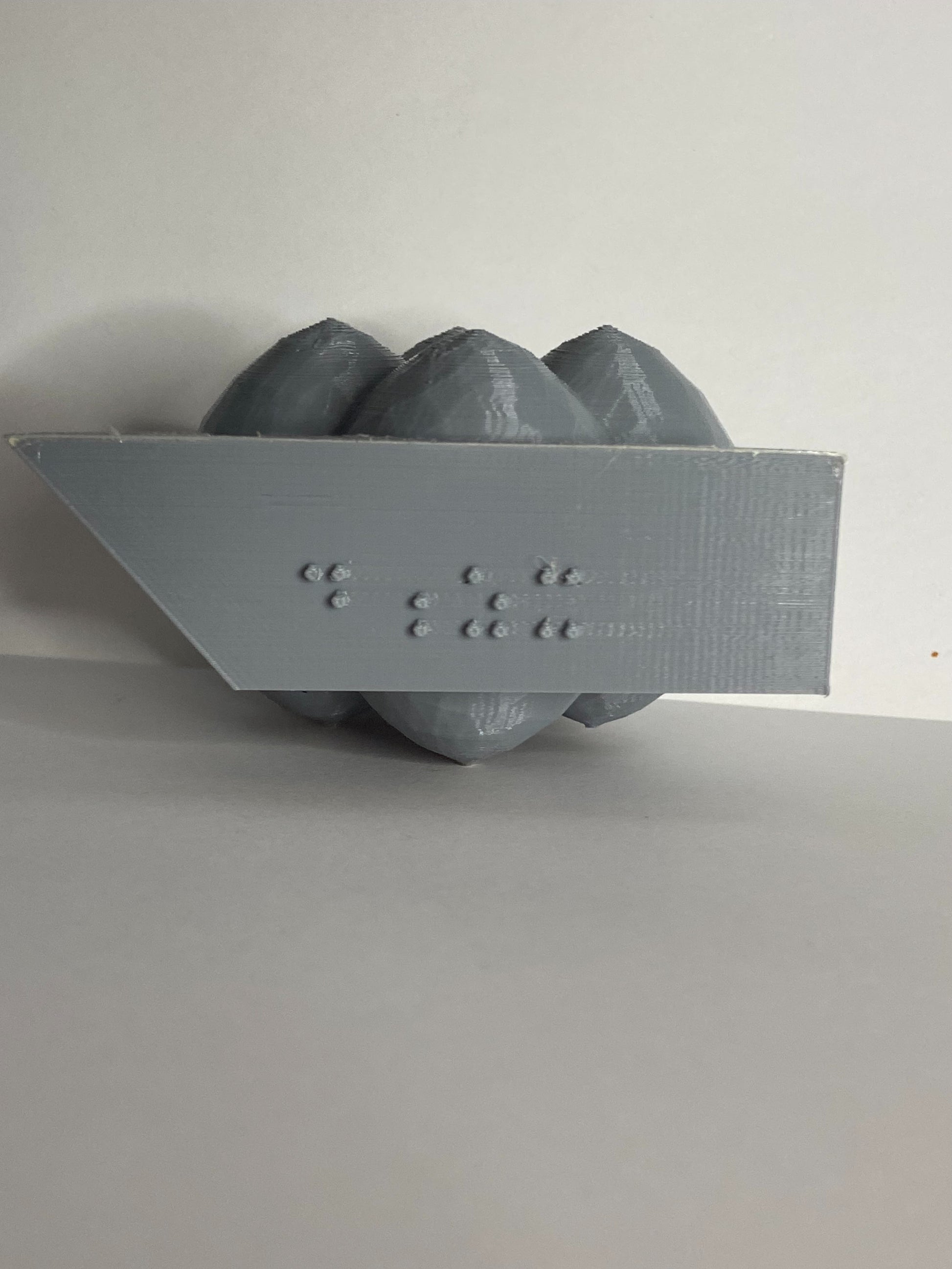 D-orbital on it's side showing the braille