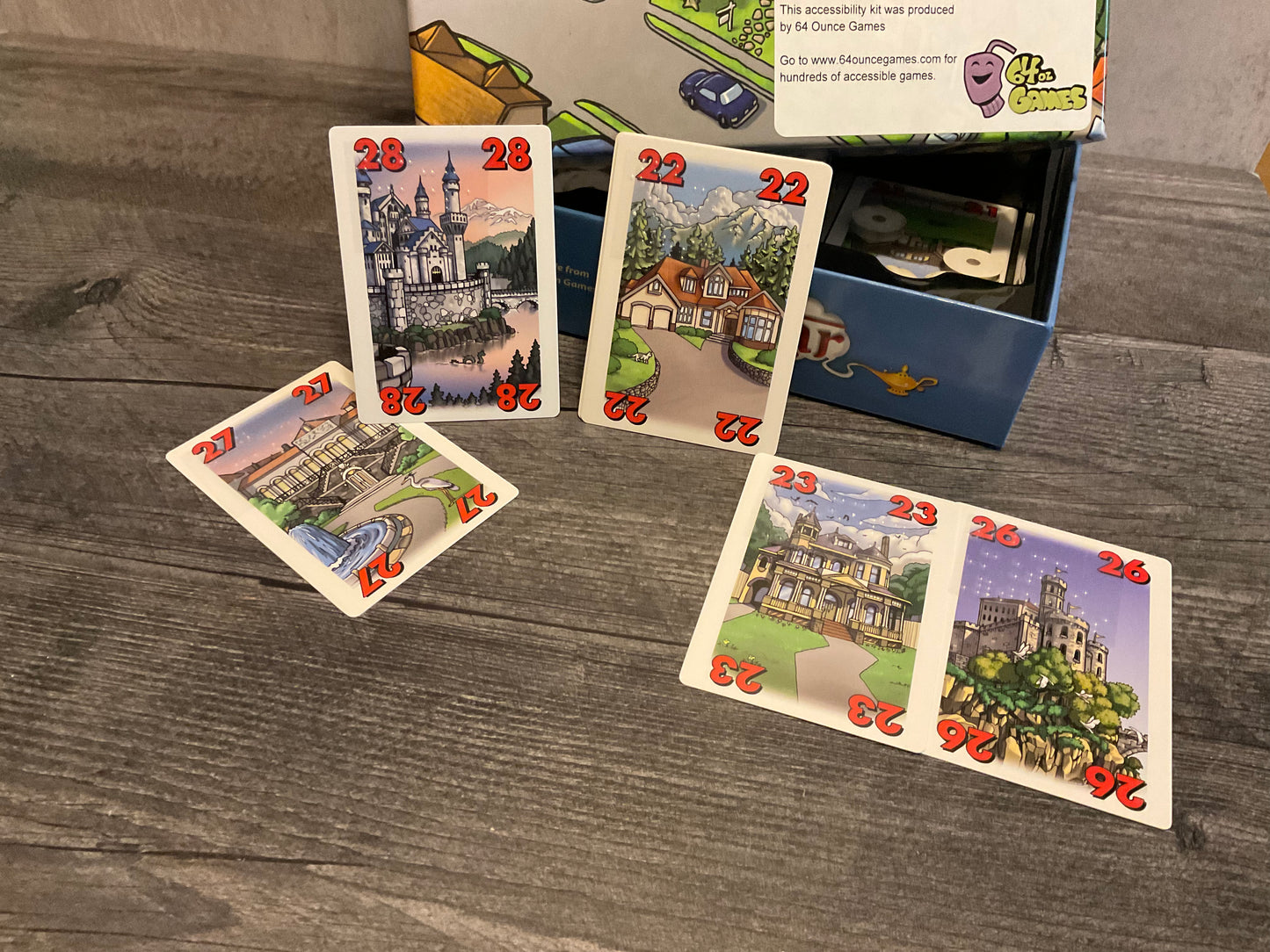 face up cards with houses and numbers on them. All cards have braille stickers on them.