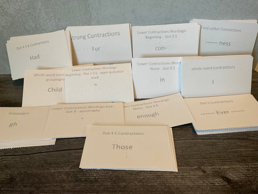 A picture of many different contraction types shown in the set, such as dot contractions, strong contractions and group signs. All index cards are embossed in interpoint with large print on the front.