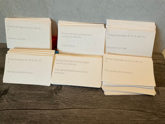 Braille Phrases on flash cards. The cards are presented in interpoint braille with large print