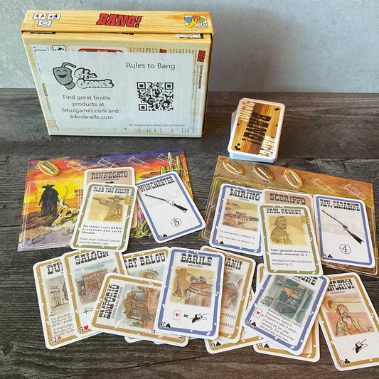 A picture of the Bang box, 2 of the player mats and various cards with braille.