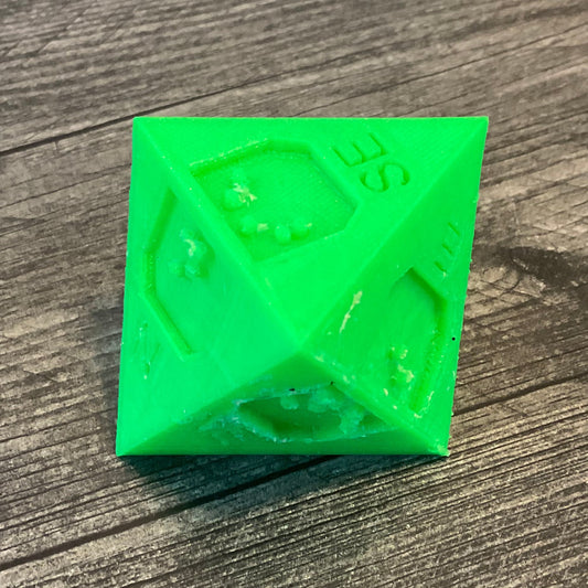 Die with SE showing on the top of the 8 sided die.