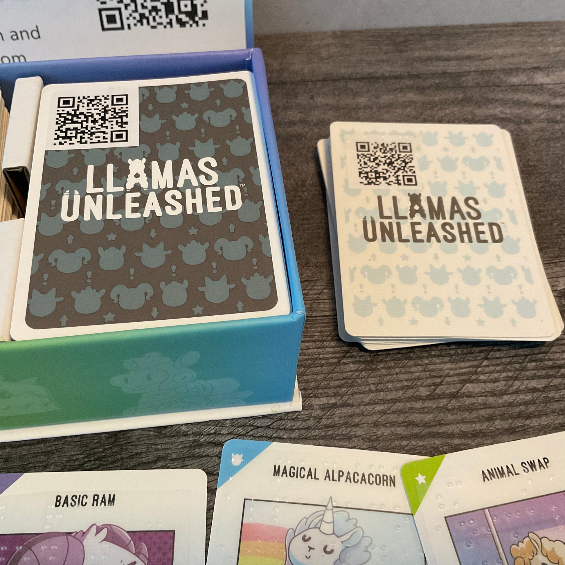 A picture of the backs of the two types of cards. Both have QR cards but the white baby cards also have a braille sticker on the back to help separate them