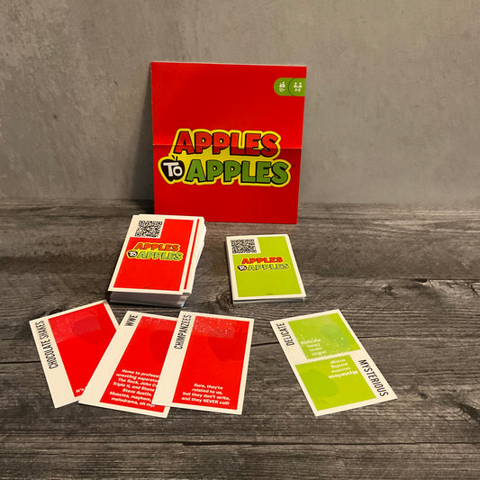 Some apples to apples cards. The transparent braille can be seen. The cards have a QR code on them for the full text.