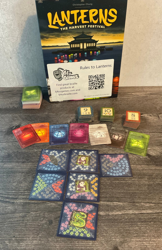 A shot of the game, the tiles, the cards and the favor tokens. All of them have transparent braille on them