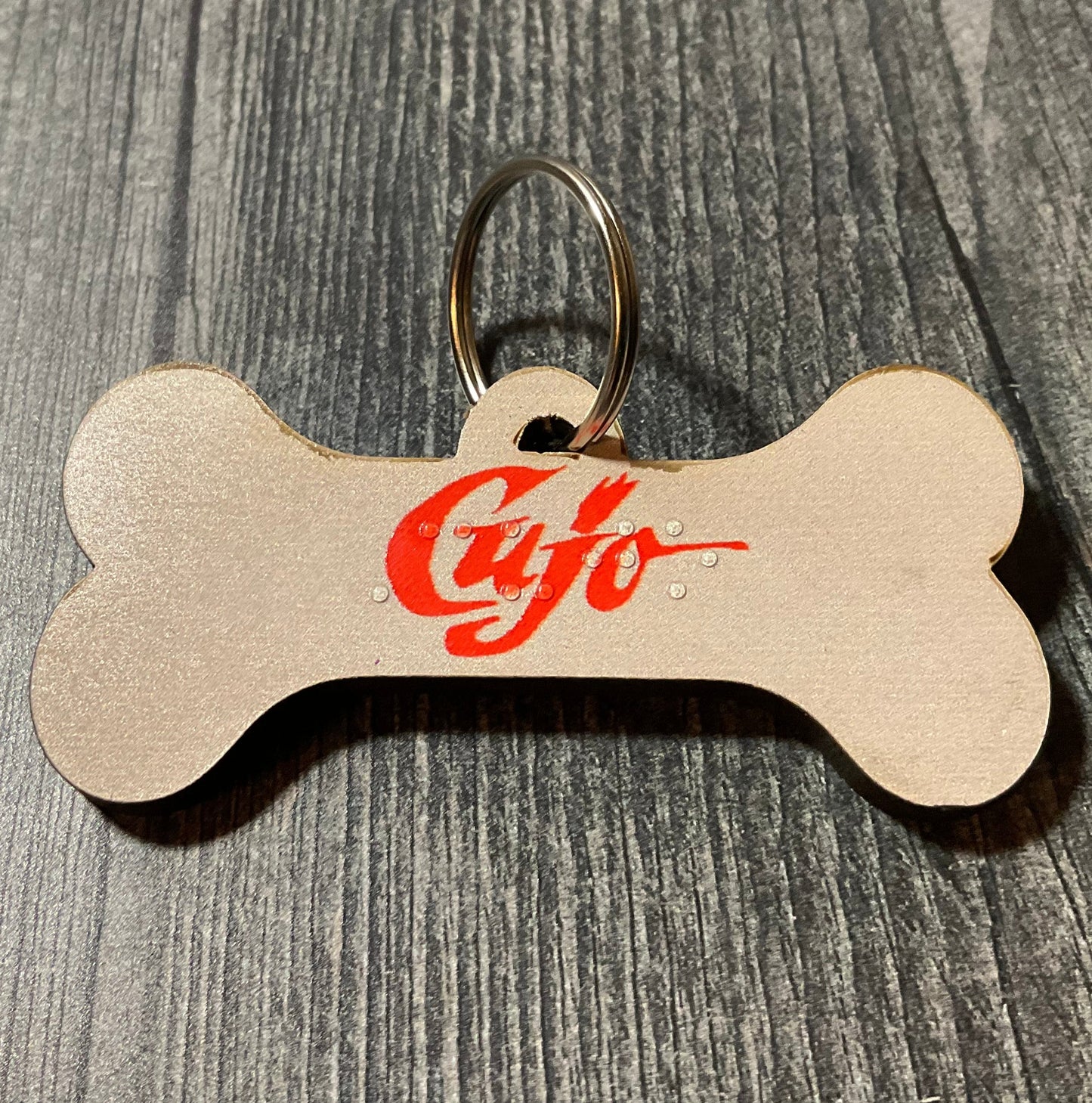 Close up on the Cujo dog tag. It uses the font from the movie violating copyright law, don't tell anyone.