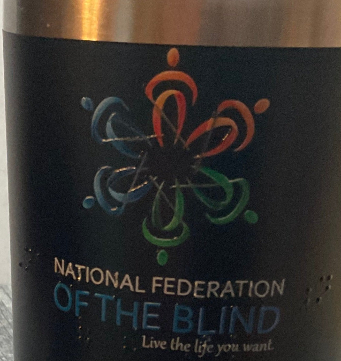 Close up of tumbler comissioned for a member of the National Federation of the Blind. The logo is tactile and it says National Federation of the Blind in braille under it.