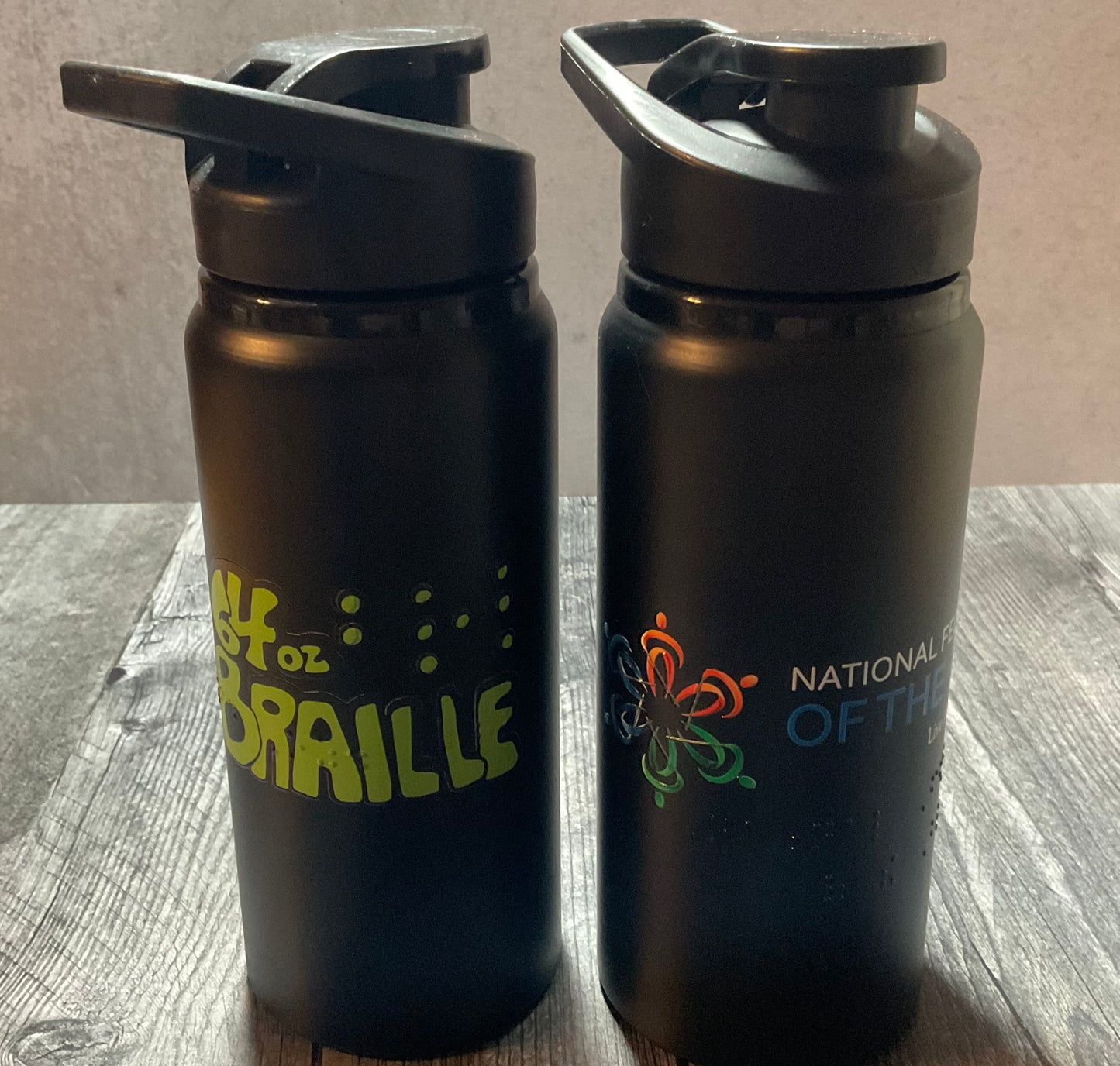 Image of two water bottles with tactile braille on them.