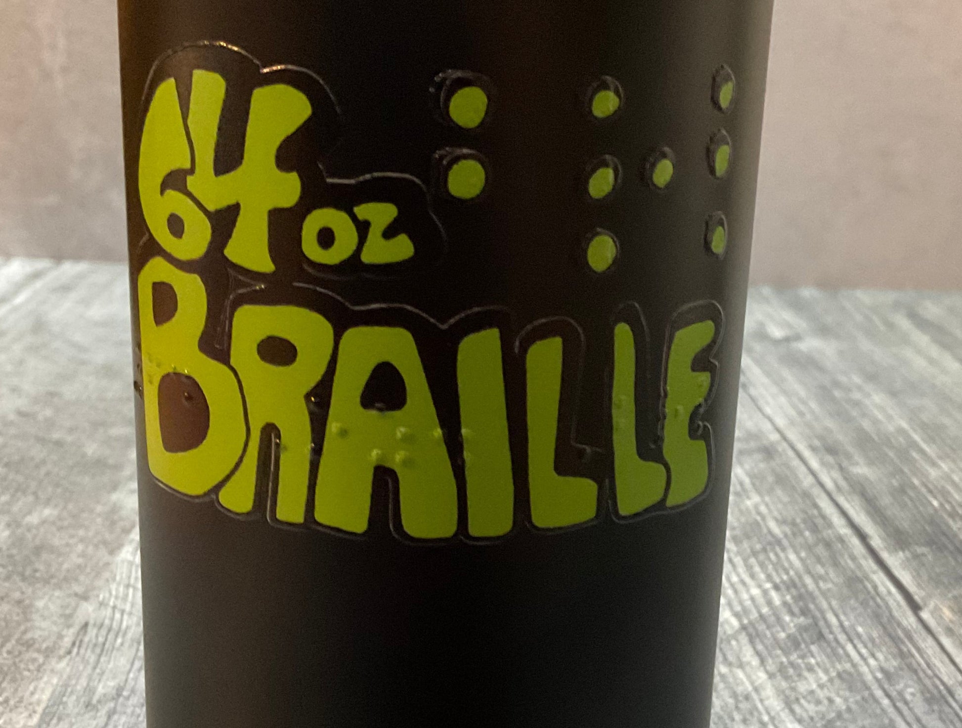 Close up on the braille on our waterbottles. You can see the tactile image as well.