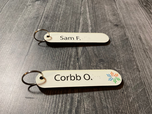 Two of the 1 x 4 cane tags. One has a tactile picture on it.