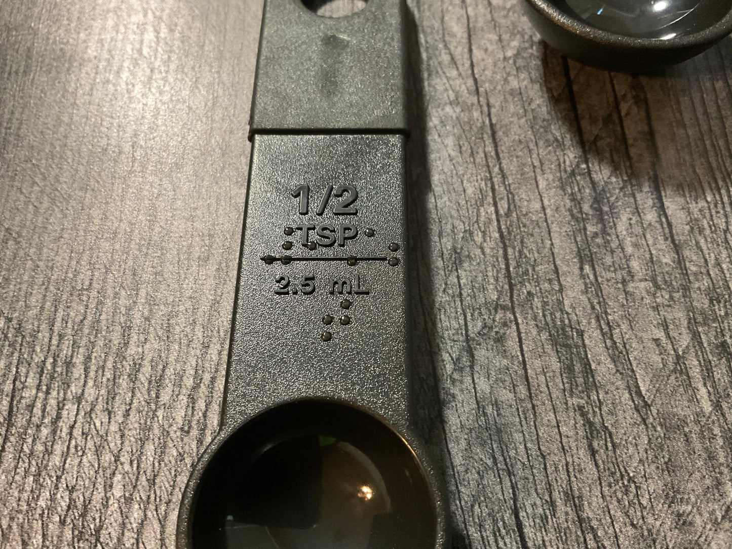 Close up on the braille on the 1/2 tsp.