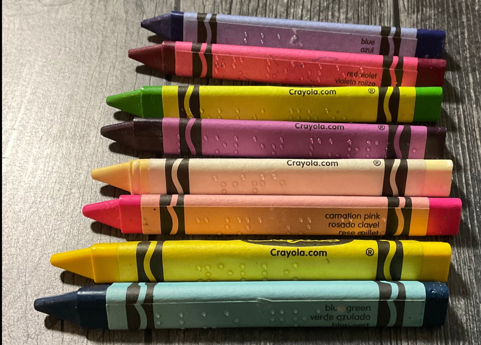 A close up on half of the crayons. You can clearly see the braille