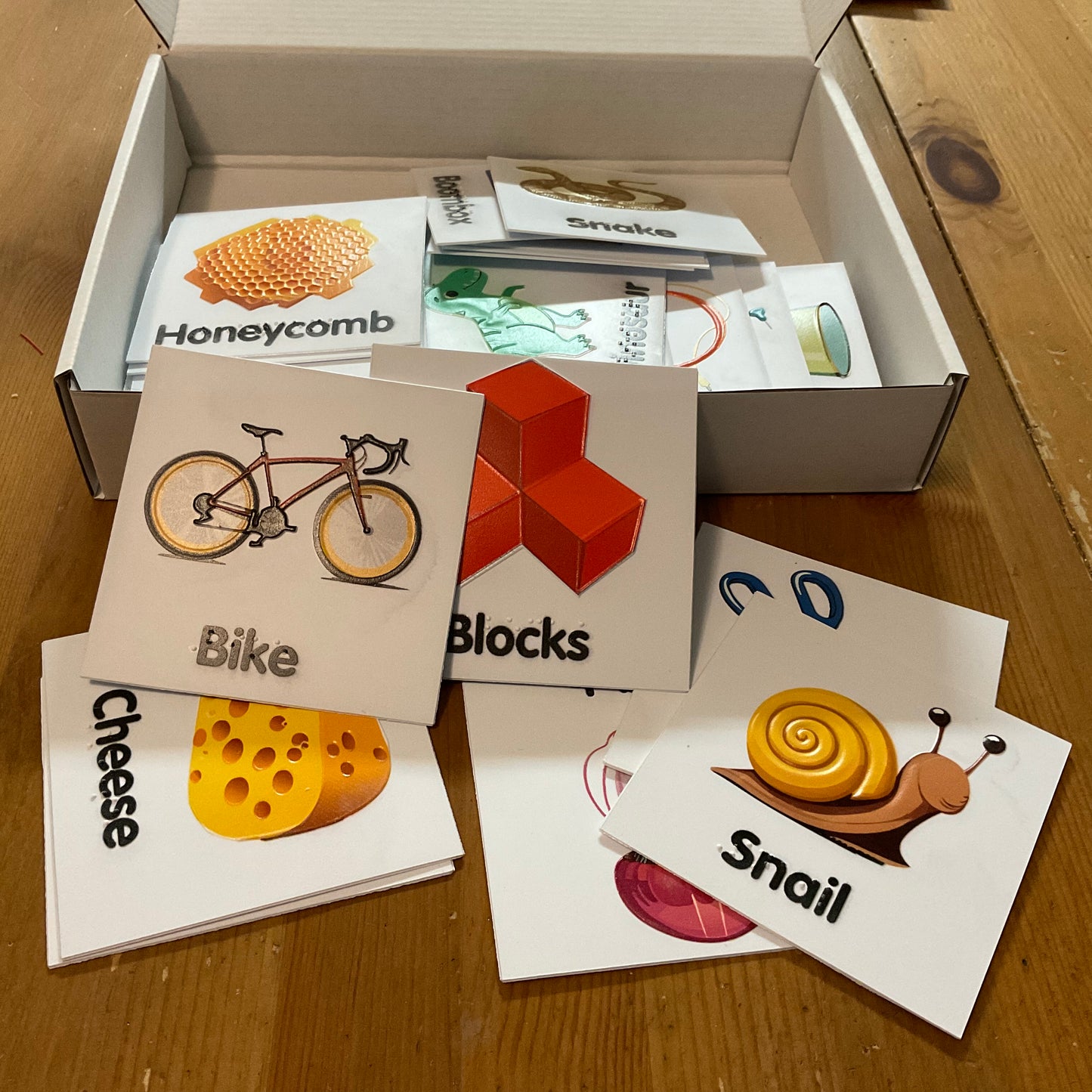 Box is open showing the tactile memory cards. A bike and a snake is in the forefront.