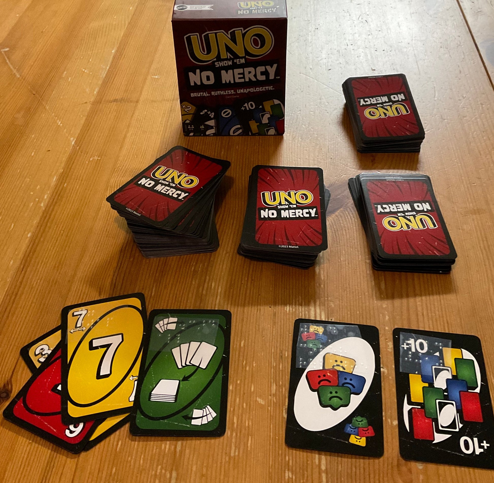 Wide shot of Uno No Mercy with braille on cards.