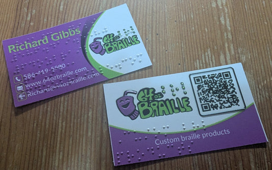 Front and back of braille business cards. The braille contains the same information as the print and a tactile box surround the QR code on the back.