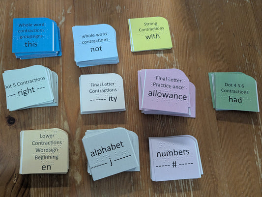 Color coded flashcards on a wooden surface with different types of cards sorted.