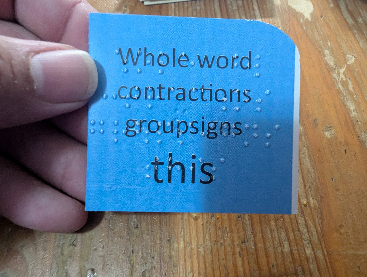 A card showing the who word contraction group sign for this.
Braille on the front explains the card and has this uncontracted and the backside has the contracted version in braille.