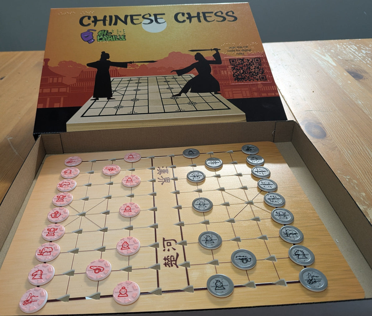 Open Chinese Chess set showing the box and the pieces setup on the board.